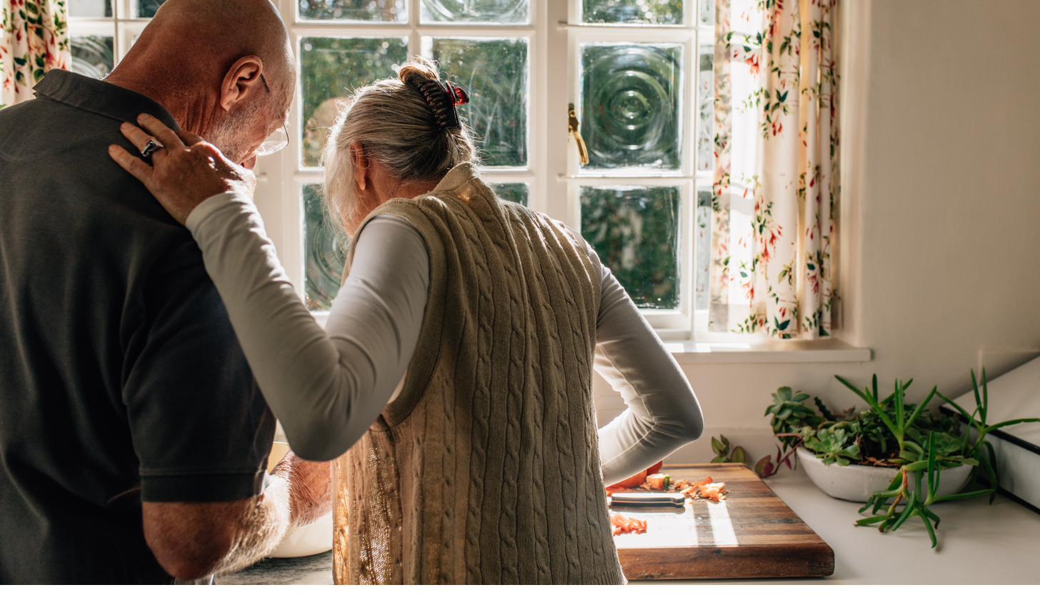 Adult child and parent looking at a tablet together