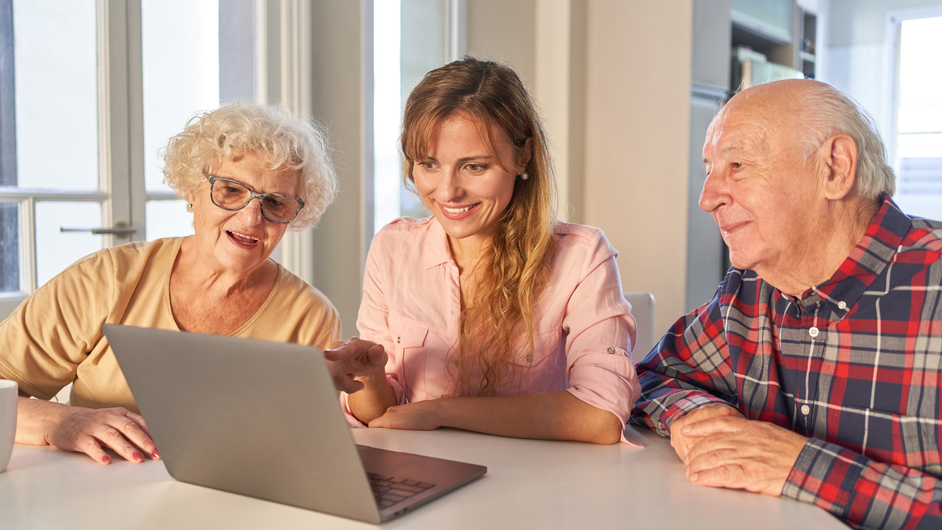 Adult child and parent looking at a tablet together