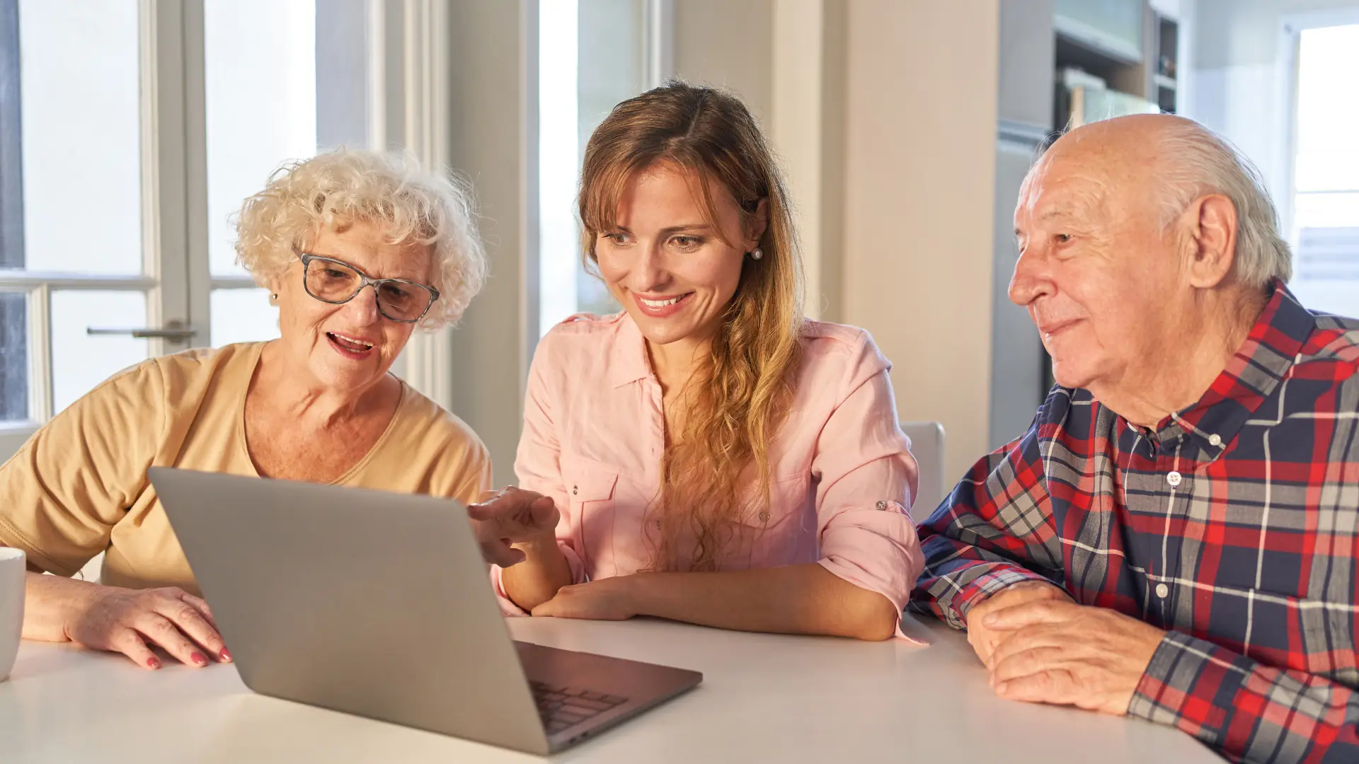 Adult child and parent looking at a tablet together